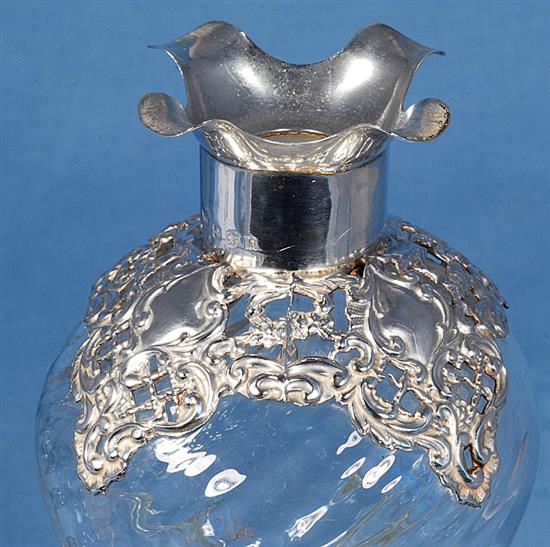 A pair of Edwardian silver mounted waisted glass decanter and stoppers,